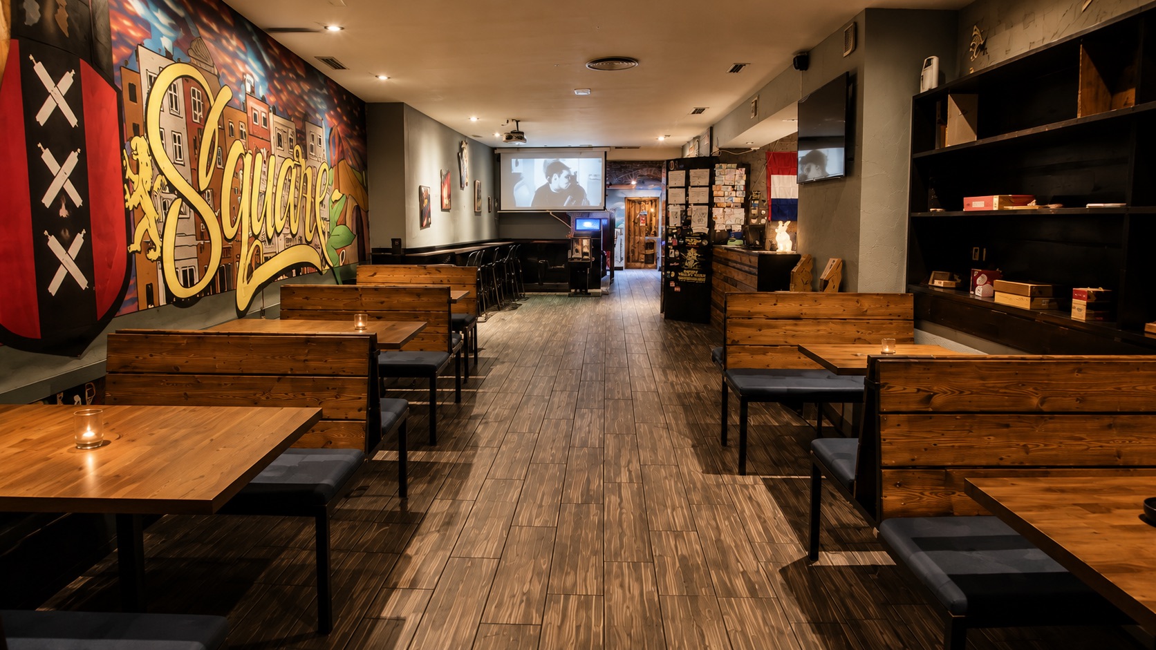 Dam Square main lounge room with Amsterdam mural